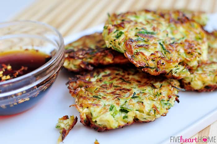 Zucchini Fritters ~ these golden, delicious fritters are crispy on the outside, creamy on the inside, and accompanied by a sweet and salty, Asian-inspired dipping sauce! | FiveHeartHome.com Close-up on a board