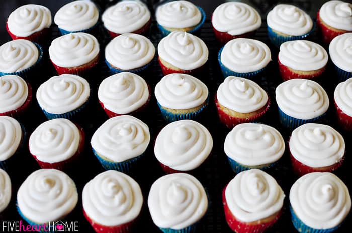 Vanilla Texas Sheet Cake Cupcakes with Cream Cheese Frosting on cooling rack.