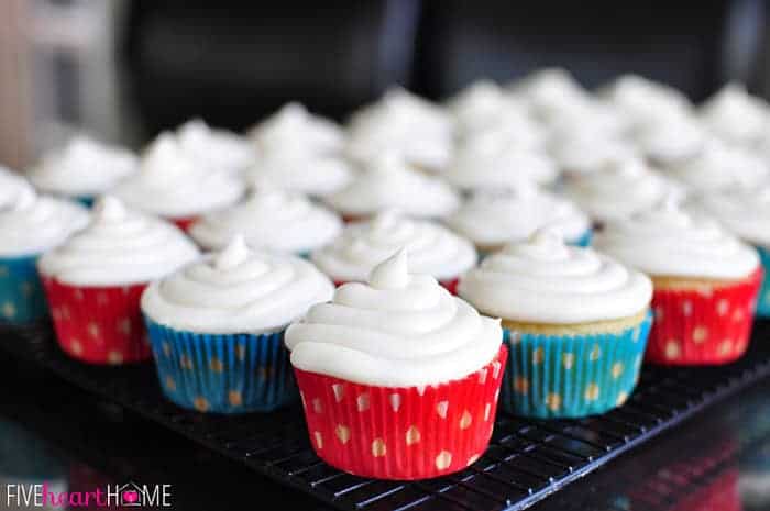 Vanilla Texas Sheet Cake Cupcakes with Cream Cheese Frosting on cooling rack.