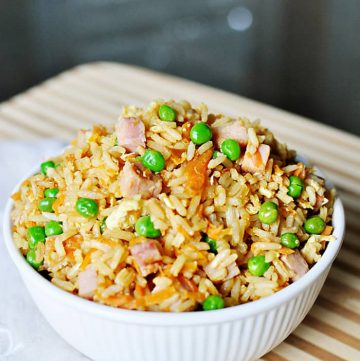 Easy Fried Rice in a white bowl in a wooden cutting board