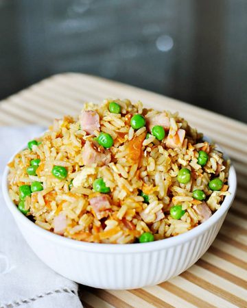 Easy Fried Rice in a white bowl in a wooden cutting board
