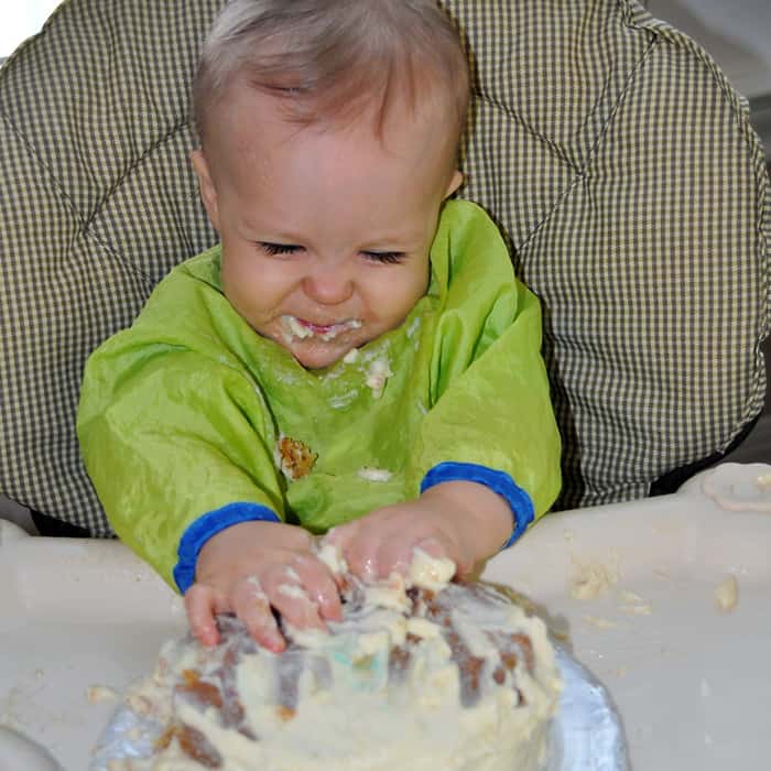Digging into first birthday smash cake