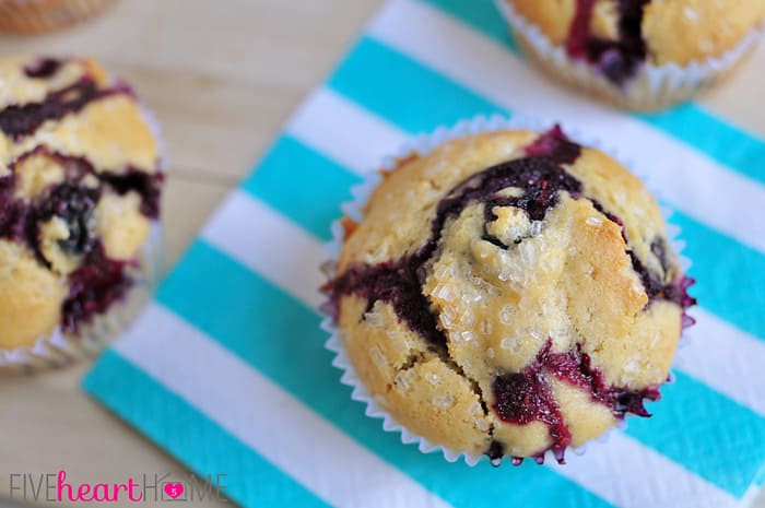 Classic Blueberry Muffins ~ these tender muffins are the BEST...bursting with berries and easy to make for a yummy breakfast or snack! | FiveHeartHome.com Aerial view of muffins on striped napkins