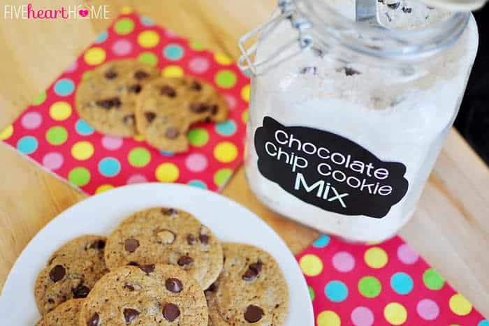 Jar of Cookie Mix next to plate of chocolate chip cookies.