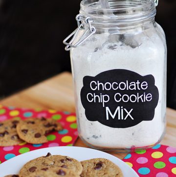 Jar of Chocolate Chip Cookie Mix with plate of fresh cookies.