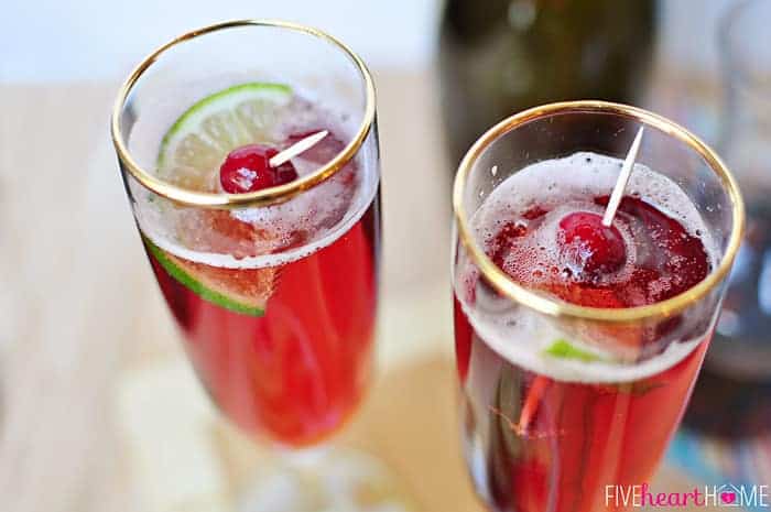Two glasses garnished with fresh cranberries and twist of lime.