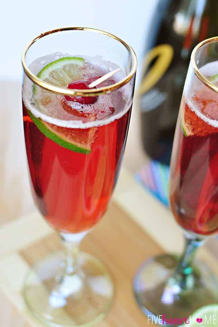 Cranberry Pomegranate Bellini with garnish in gold-rimmed glass.