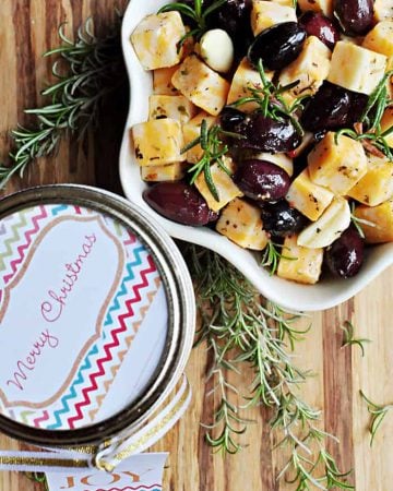 Aerial shot of Marinated Cheese & Olives in a bowl and gift jar.