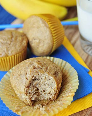 Whole Wheat and Honey Banana Muffins with liner peeled back and bite missing