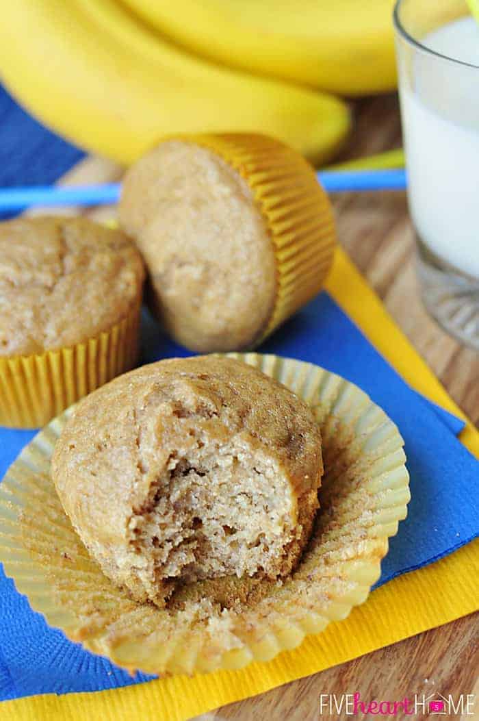 Healthy Banana Muffins ~ these muffins are delicious and wholesome, boasting healthy ingredients including whole wheat flour, coconut oil, yogurt, and honey! | FiveHeartHome.com Liner peeled back and bite missing,
