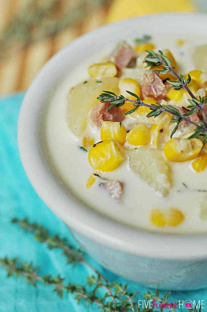 Slow Cooker Corn and Potato Chowder with Ham in a White Bowl Garnished with Fresh Thyme Sprigs