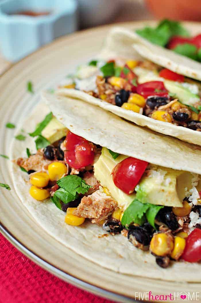 Plate of Slow Cooker Chicken Tacos made with flour tortillas.
