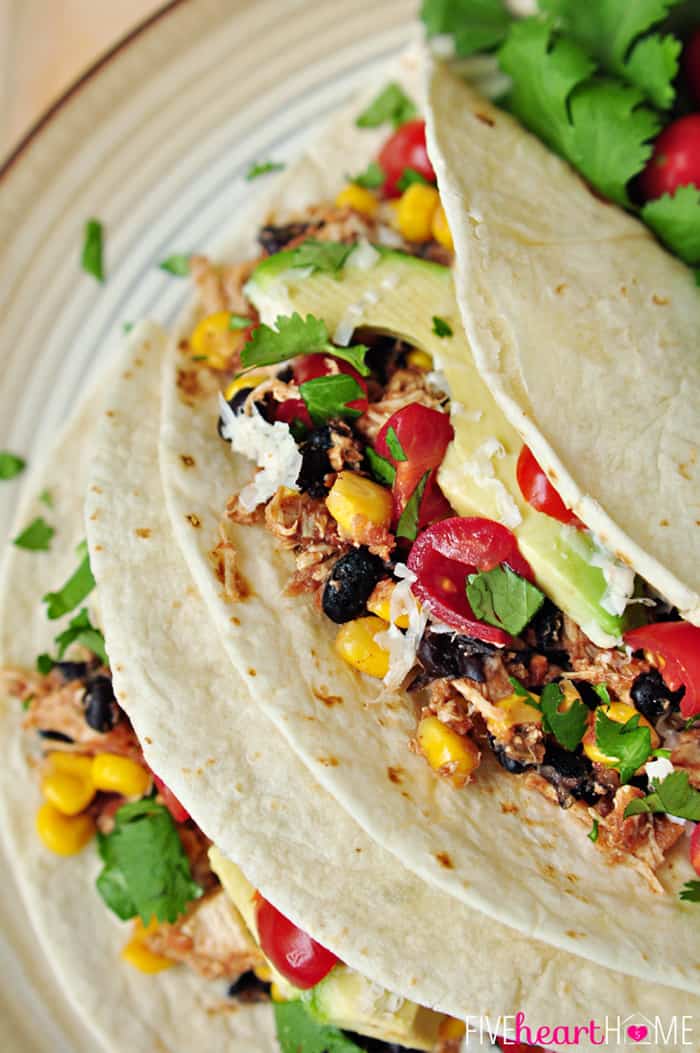 Aerial plate of Slow Cooker Chicken Tacos with toppings.