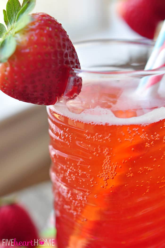 Close-up of strawberry garnish on glass of Strawberry Soda.