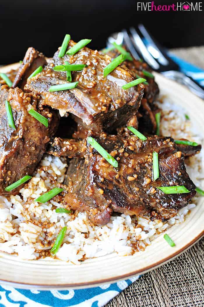 Asian Short Ribs served over rice on a plate.