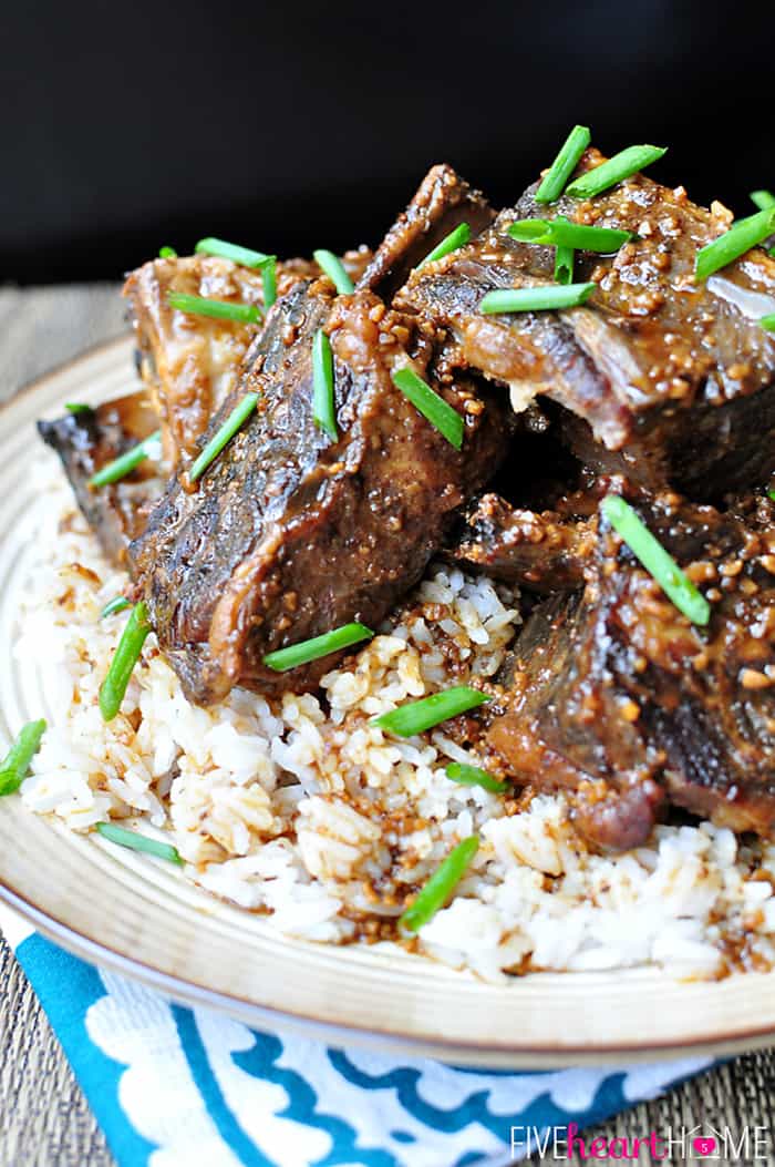 Asian Short Ribs over rice on a plate.