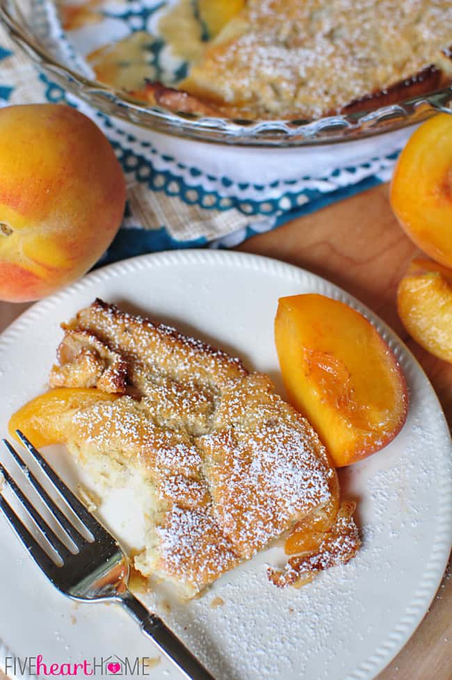 Peach German Pancake (Dutch Baby) ~ golden, puffy, and piping hot skillet pancake studded with peaches | FiveHeartHome.com Aerial view of Peach German Pancake on plate with missing bite.