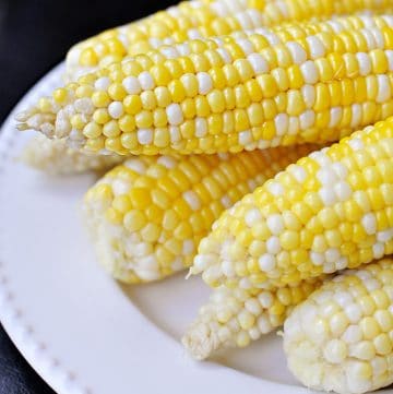 The Easiest, Tastiest, BEST Way to Cook Fresh Corn on the Cob: Oven Roasting! Simply wash & cook...once done, husks and silk peel away with no mess! | FiveHeartHome.com