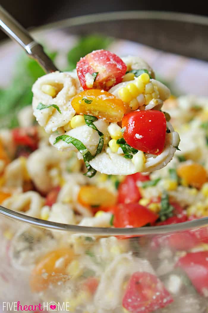 Large Spoonful of Tortellini Pasta Salad with Tomatoes, Basil, and Fresh Corn 