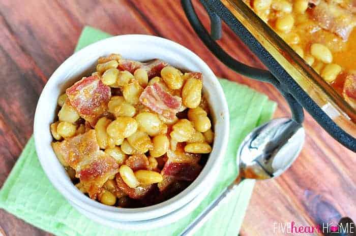 Easy Southern Baked Beans ~ this sweet and savory side dish is topped with bacon, and it's quick to whip up using canned white beans | FiveHeartHome.com Aerial view of Southern Baked Beans in serving dish and baking dish.