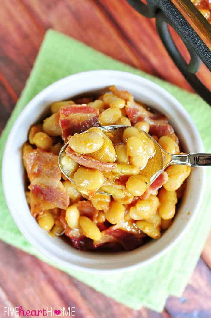 Aerial view of Southern Baked Beans in bowl with spoon.