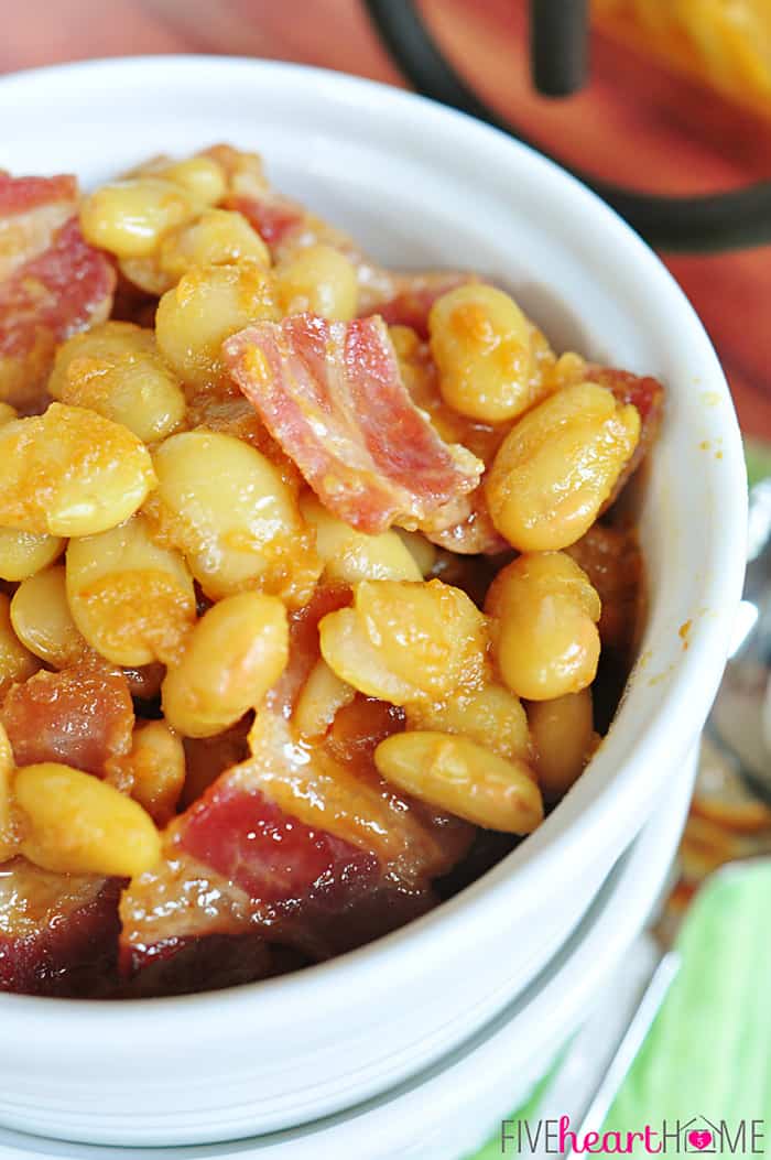 Easy Southern Baked Beans ~ this sweet and savory side dish is topped with bacon, and it's quick to whip up using canned white beans | FiveHeartHome.com Close-up of Southern Baked Beans in bowl.