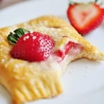 Strawberry Pastry on plate with missing bite.