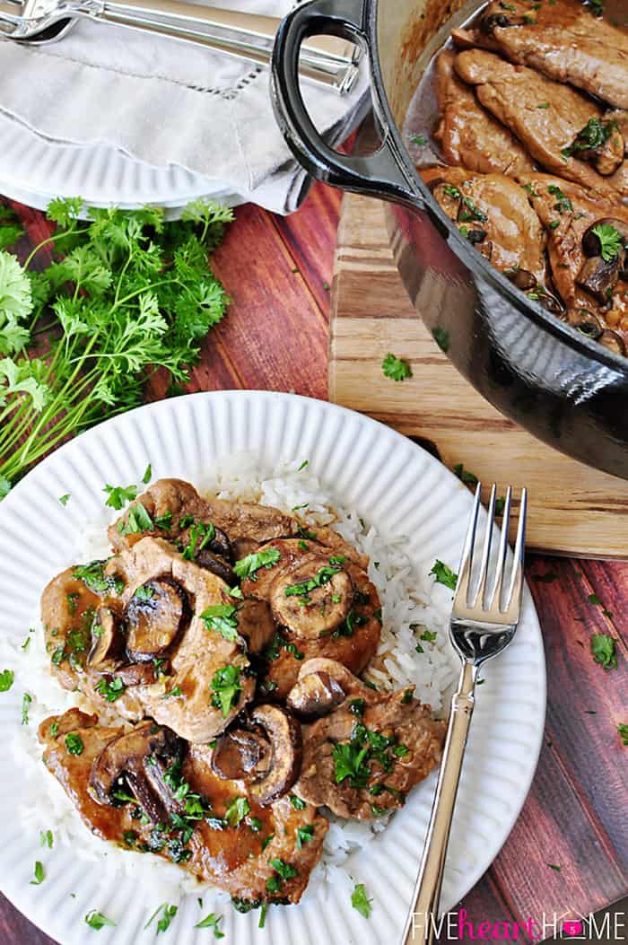 Pork Tenderloin with Mushroom Gravy ~ quick stovetop supper featuring tender medallions of pork in a savory mushroom gravy | FiveHeartHome.com Aerial view of Pork Tenderloin with Mushroom Gravy on white plate with fork.