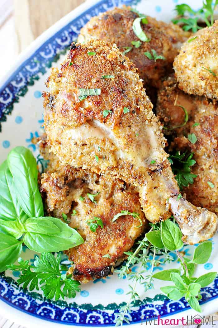 Close-up of Baked Italian Chicken on a platter, garnished with fresh herbs.