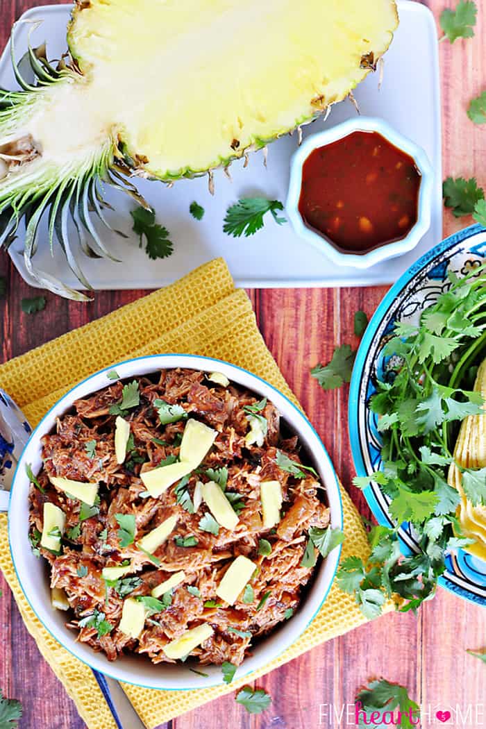 Aerial View of Serving Bowl, Fresh Pineapple Cut in Half and Dish of BBQ Sauce 