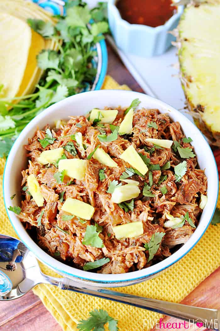 Slow Cooker Pineapple Pulled Pork with Pineapple BBQ Sauce Garnished with Fresh Pineapple and Cilantro 