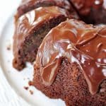 Sliced Chocolate Zucchini Bundt Cake with Chocolate Glaze on platter.