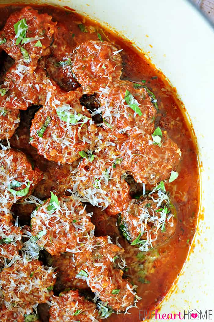 Aerial close-up in pot garnished with grated parmesan and fresh parsley.