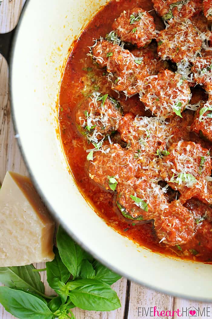 Aerial view of zucchini in spaghetti sauce simmering in pot.