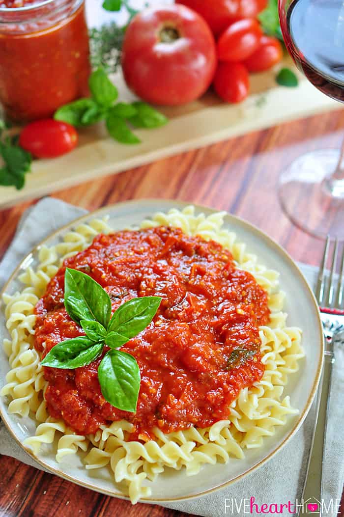 Plate of pasta topped with Marinara Sauce with Fresh Tomatoes.