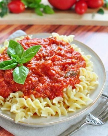 30-Minute Marinara Sauce with Fresh Tomatoes over plate of pasta.
