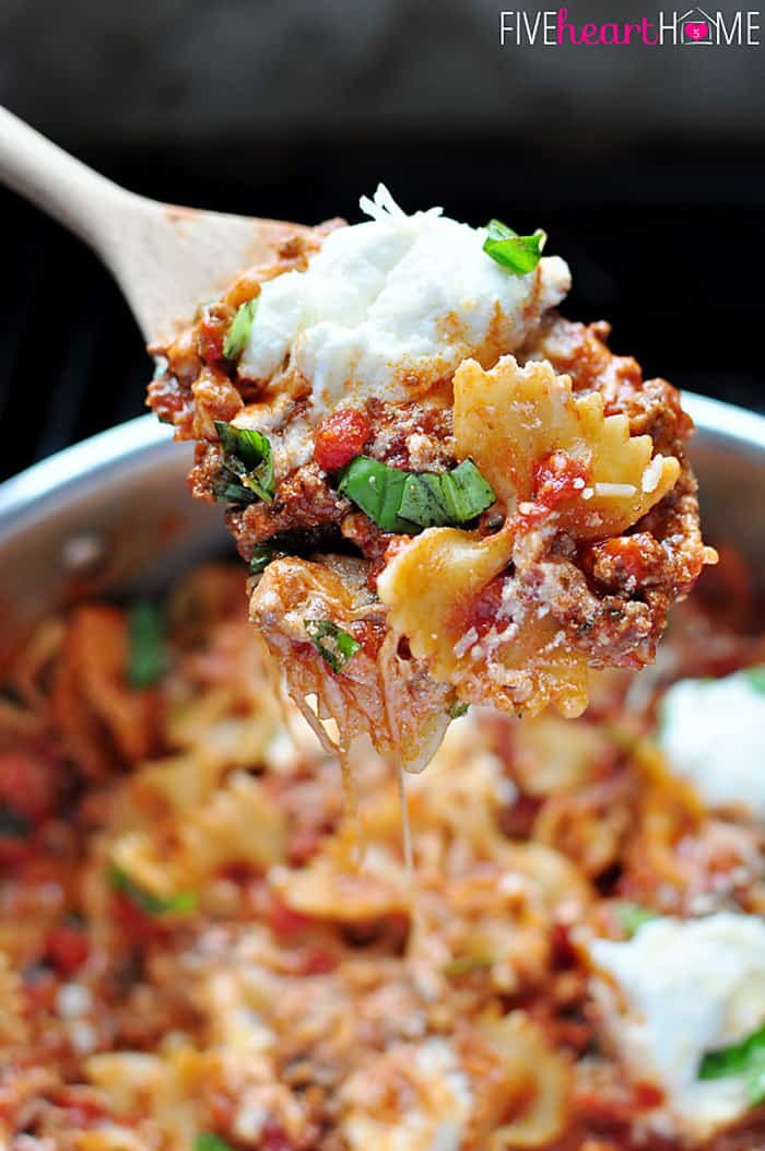 Scoop of 30-Minute Skillet Lasagna on a wooden spoon.