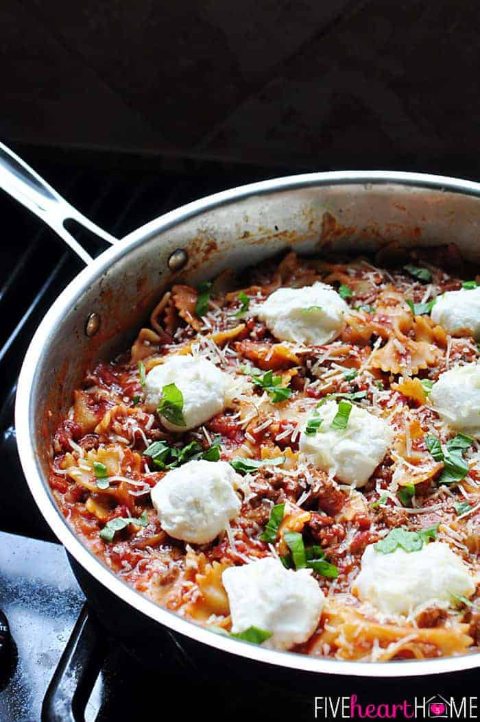 Skillet Lasagna in pan on the stove, topped with dollops of ricotta.