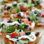 French Bread Taco Pizza sliced on cutting board