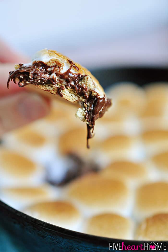 Big bite of S'mores Dip on graham cracker.