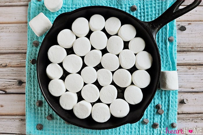 S'mores Dip ~ melted chocolate and toasty marshmallows bake up in a skillet; scoop up with graham crackers for a perfect party dessert! | FiveHeartHome.com Aerial view of skillet ready to go into the oven.