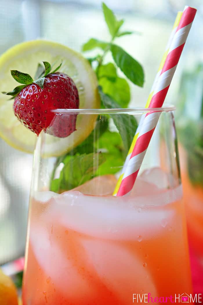 In a Frosty Glass with Fresh Garnish of Strawberries, Lemon and Mint 