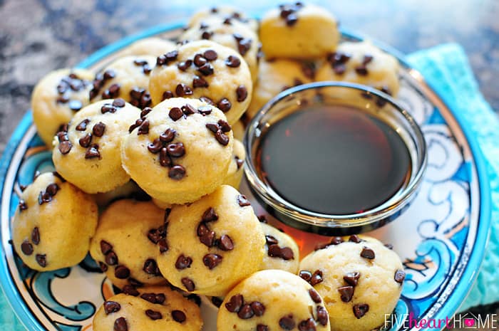 Whole Wheat Pancake Bites, AKA Pancake Mini Muffins ~ a fun-to-eat breakfast that can be topped with chocolate chips, berries, diced bananas, nuts, etc. | FiveHeartHome.com Whole Wheat Pancake Bites on decorate plate with syrup for dipping.