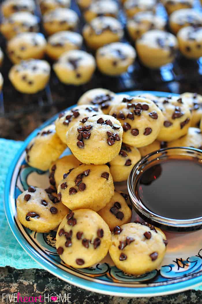 Whole Wheat Pancake Bites, AKA Pancake Mini Muffins ~ a fun-to-eat breakfast that can be topped with chocolate chips, berries, diced bananas, nuts, etc. | FiveHeartHome.com Platter piled high with bowl of syrup for dipping.