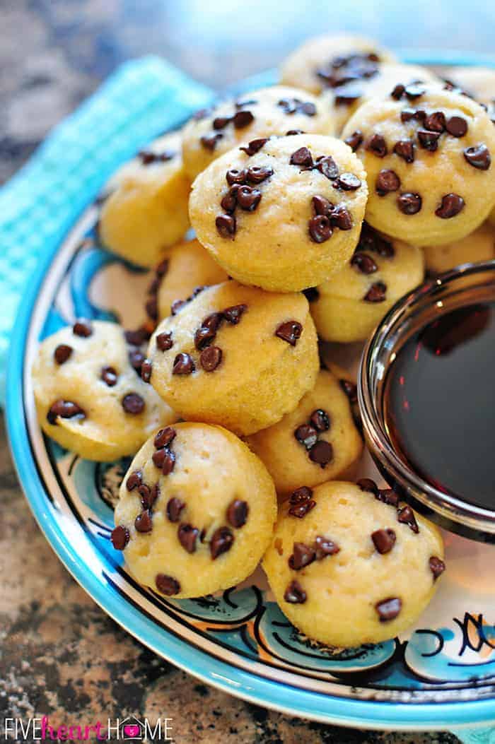 Whole Wheat Pancake Bites, AKA Pancake Mini Muffins ~ a fun-to-eat breakfast that can be topped with chocolate chips, berries, diced bananas, nuts, etc. | FiveHeartHome.com Platter of Pancake Bites with syrup.