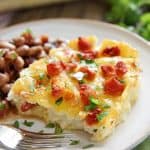 Serving of King Ranch Chicken Casserole on plate with beans.