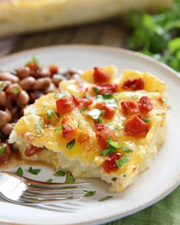 Serving of King Ranch Chicken Casserole on plate with beans.