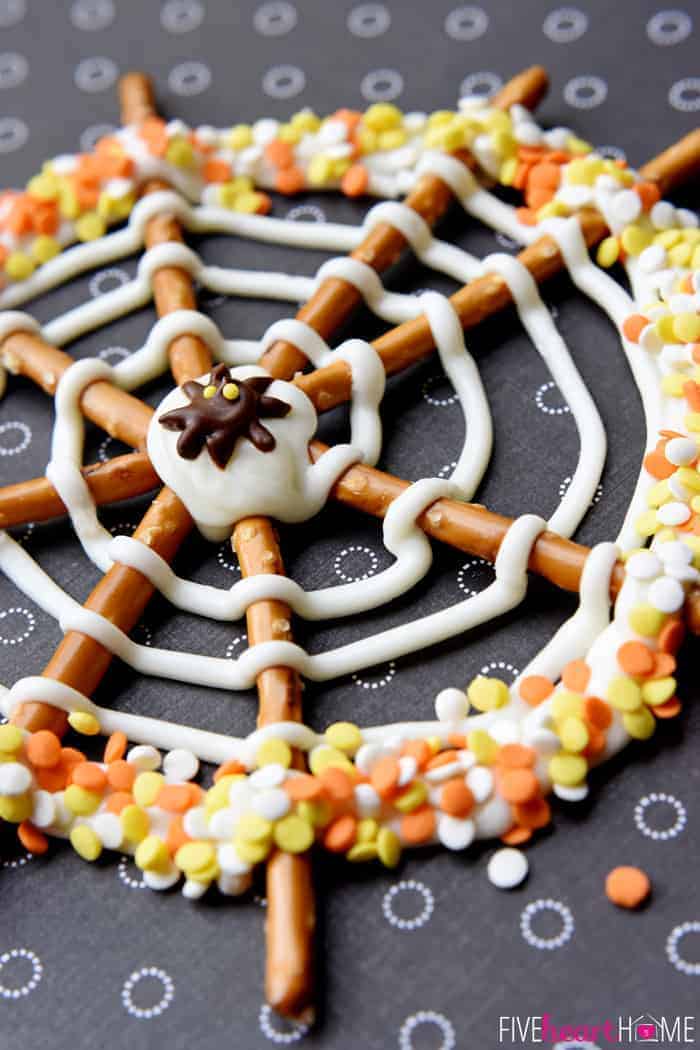 Pretzel Candy Spiderweb with orange, yellow, and white sprinkles and chocolate spider in the center