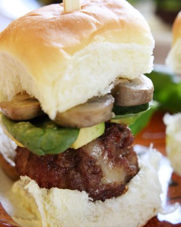 The ULTIMATE Cheeseburger Sliders ~ burger stuffed with pepper jack cheese and topped with mushrooms, avocado, and baby spinach on a Hawaiian roll | FiveHeartHome.com
