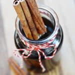 Homemade Cinnamon Syrup in glass jar with cinnamon sticks.